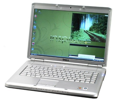 Dell Inspiron 1520 laptop opened displaying desktop wallpaper.