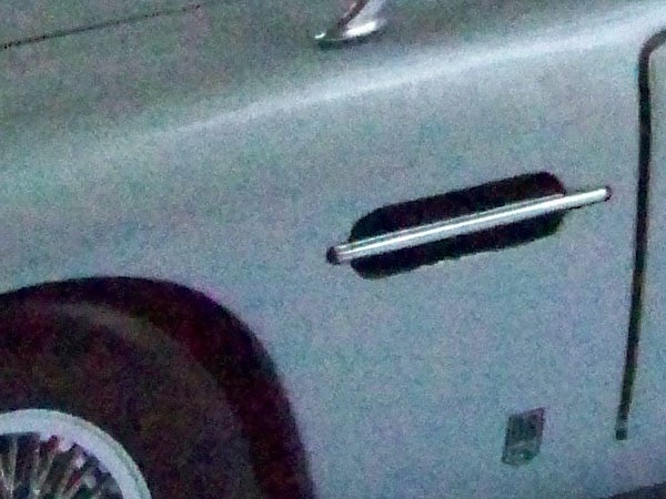 Blurry image of a car door and handle.