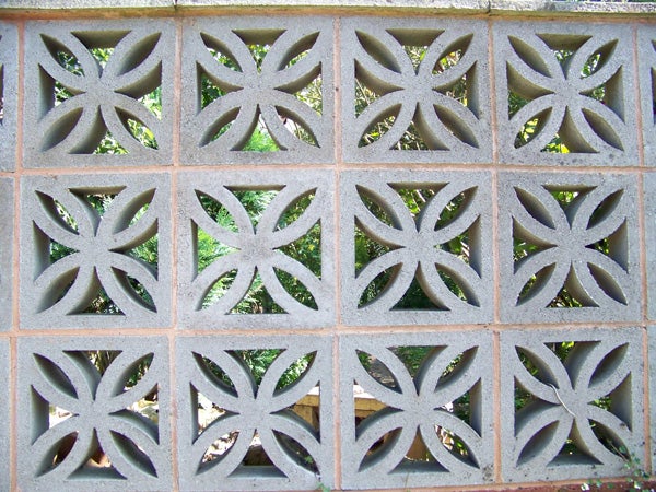 Decorative block wall with geometric patterns.