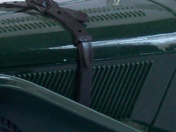 Blurred photo of a car wiper on windshield taken by Kodak C743.