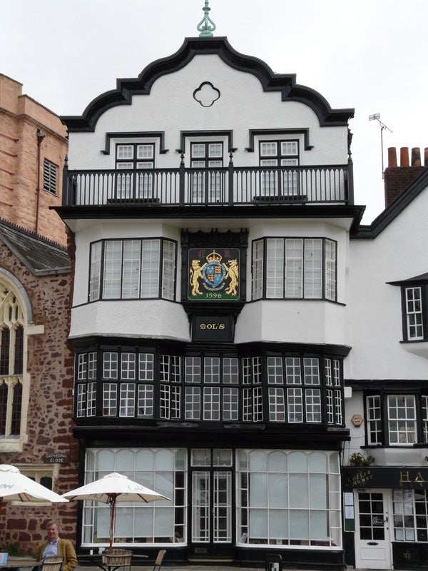 Traditional half-timbered building with ornate crest.