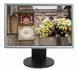 NEC MultiSync LCD2470WNX monitor displaying clock tower and flowers.