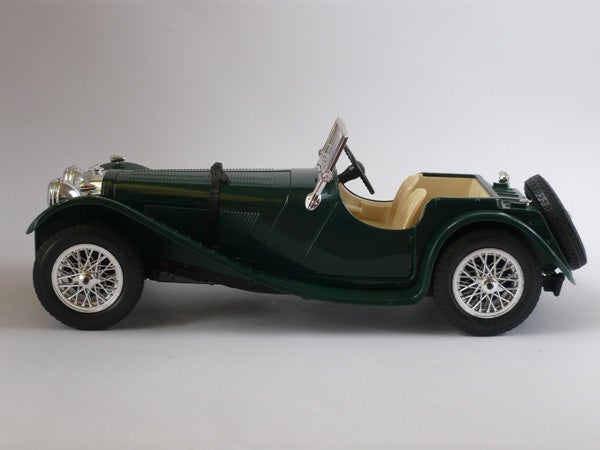 Vintage green model car on a white background.