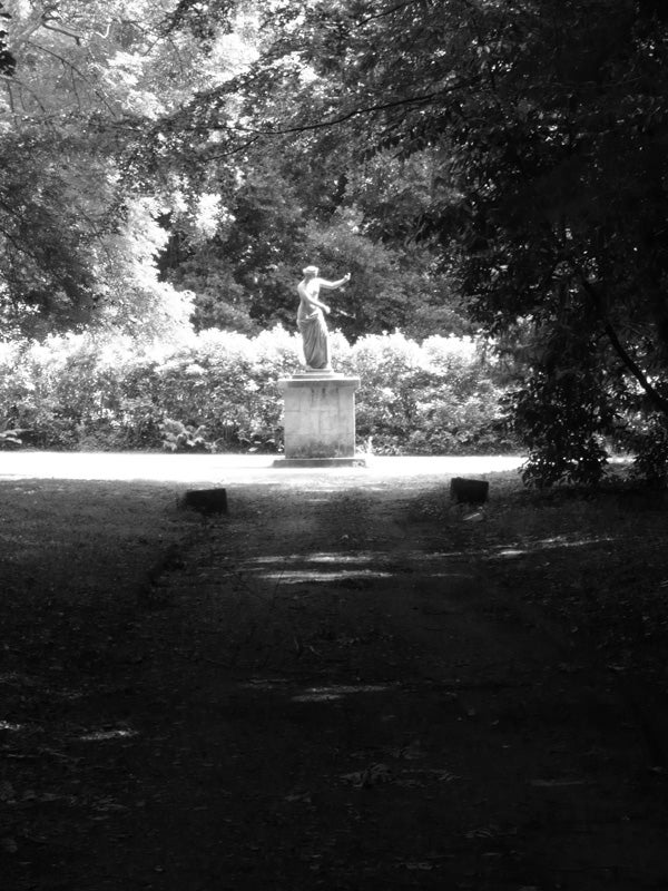 Black and white photo of a statue in a park