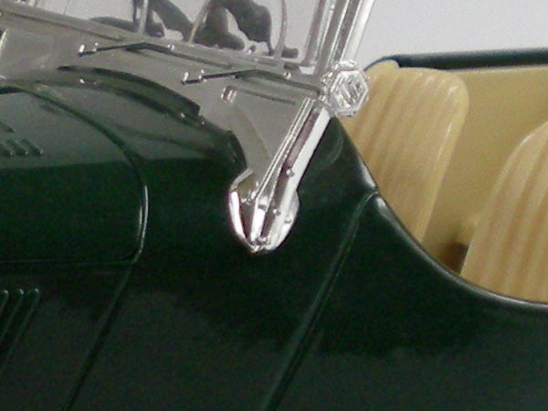 Close-up of metallic detail on a vintage green car model