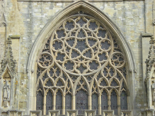 Intricate gothic window architecture with ornate stone tracery.