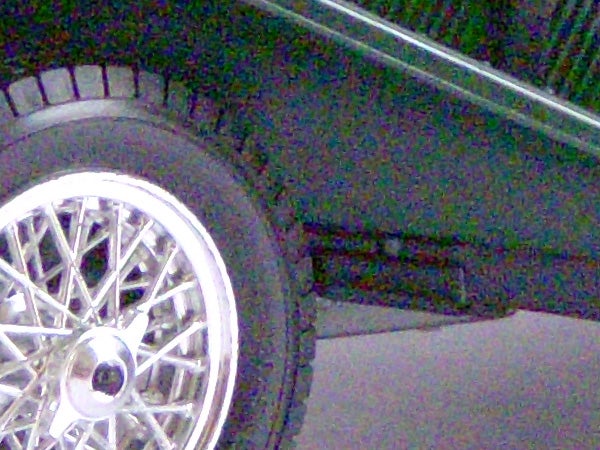 Close-up of a car wheel with a spoked rim.