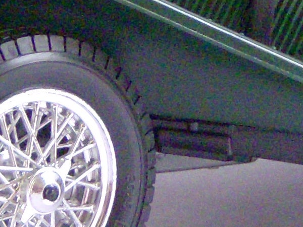 Close-up of a car wheel and fender.