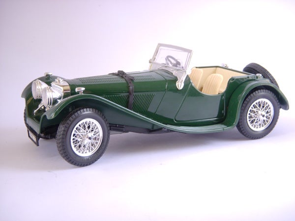 Green vintage model car on a white background.