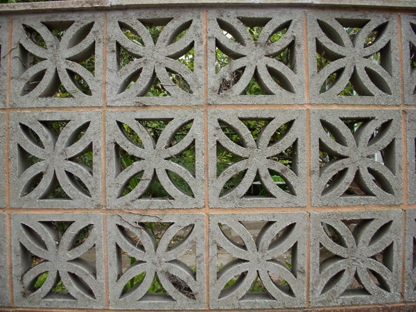 Decorative concrete block wall with a leafy background