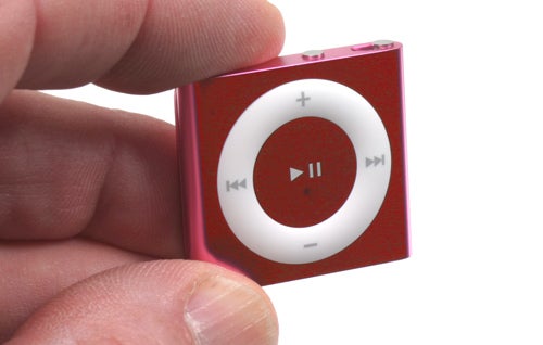 Close-up of a red iPod shuffle in a hand.