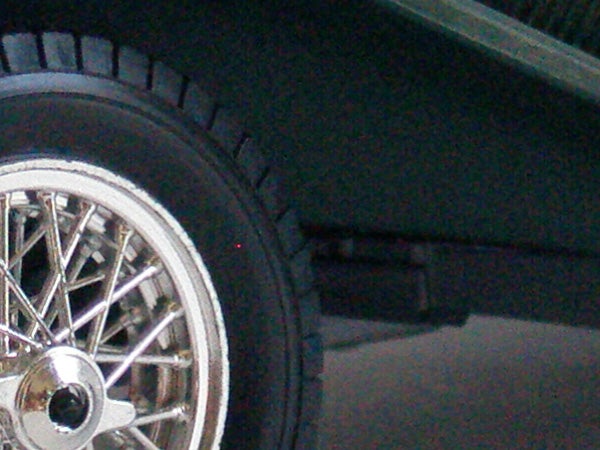 Close-up of a car wheel with a black tire and chrome spokes