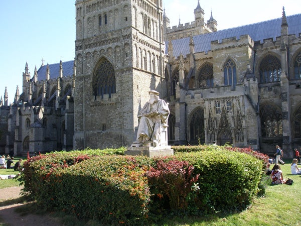 Photo taken with Olympus FE-250 showing a statue and cathedral facade.