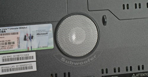 Close-up of Toshiba Qosmio G40-10E laptop's subwoofer and stickers.