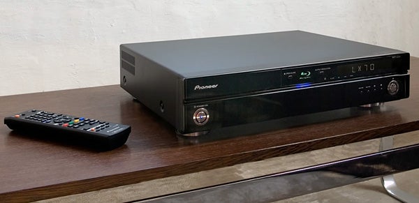 Pioneer BDP-LX70 Blu-ray player with remote on table.