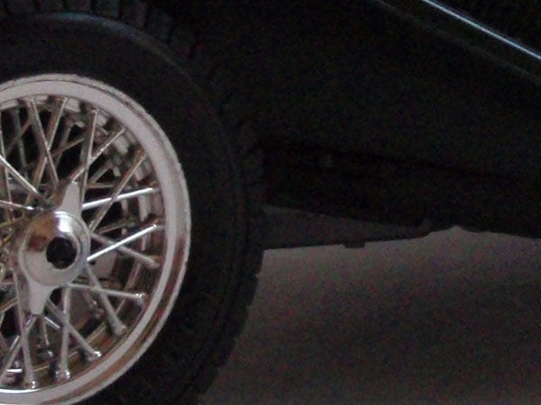Close-up of a car wheel with a spoke rim design.