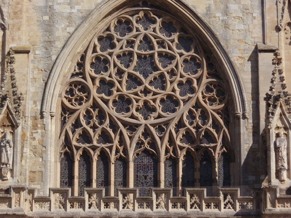 Intricate Gothic architecture of a cathedral's rose window.