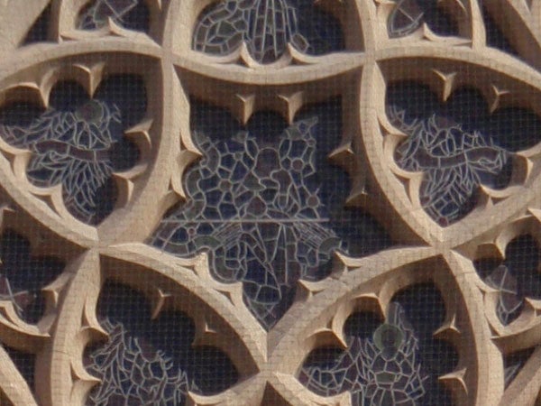 Close-up of intricate stonework patterns on a building facade.