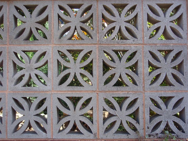 Decorative concrete block wall with geometric patterns.