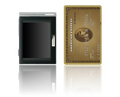 Cowon D2 DMB 4GB MP3 player next to a gold credit card.
