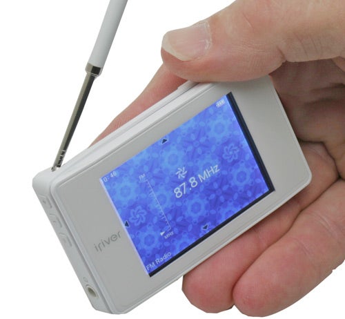 Hand holding iRiver B20 MP3 player with stylus