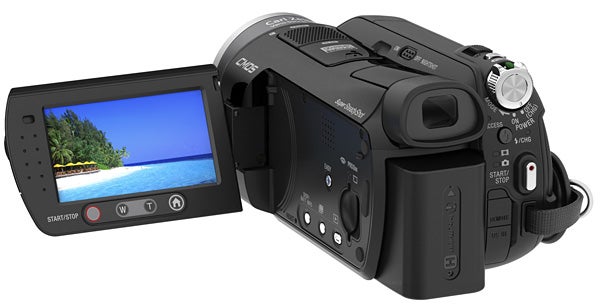 Sony HDR-SR8E camcorder with flip-out LCD screen displaying beach scene.