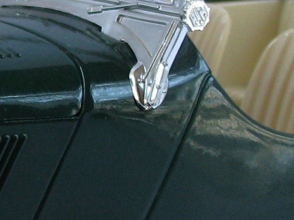 Close-up of a camera's pop-up flash hinge mechanism.