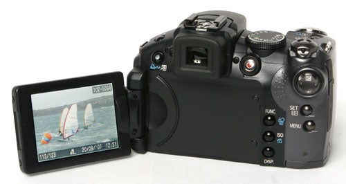 Canon PowerShot S5 IS camera with flip-out screen displayed.