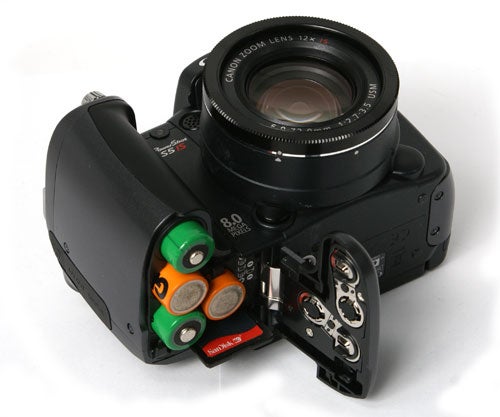 Canon PowerShot S5 IS camera with battery compartment open.