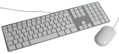 Apple iMac keyboard and mouse on white background.
