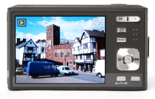BenQ DC E1000 camera displaying a street scene on its LCD screen.