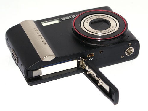 BenQ DC E1000 digital camera with open battery compartment.