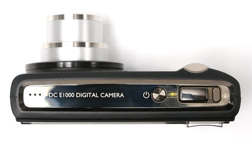 BenQ DC E1000 digital camera side view showing buttons and ports.