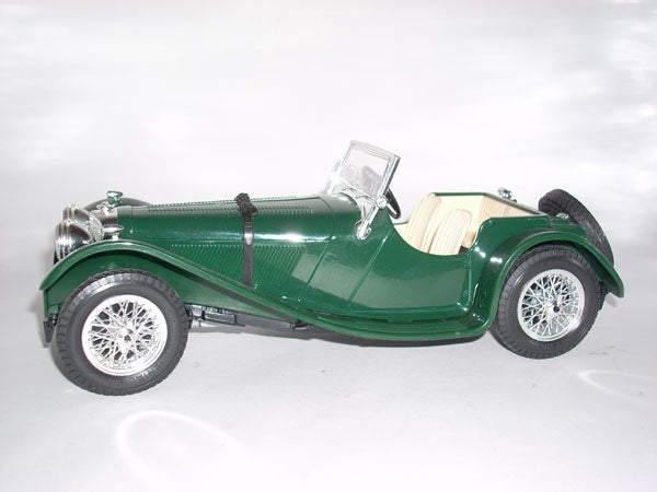 Green vintage toy car model on a white background