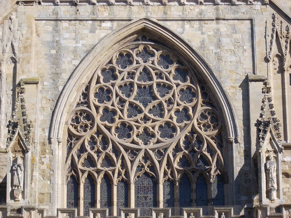 Gothic church window intricate stone tracery detail.