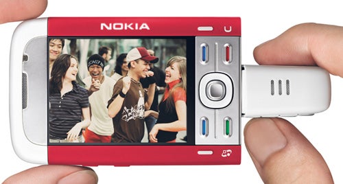 Hands holding Nokia 5700 XpressMusic phone with screen image