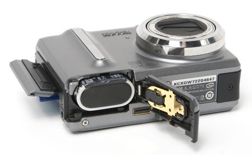 Kodak EasyShare Z1275 camera with open battery compartment.