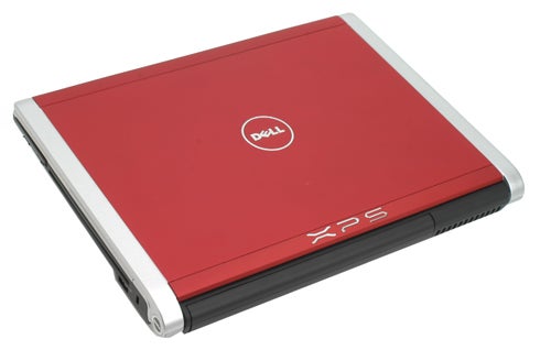 Red Dell XPS M1330 laptop closed on white background.