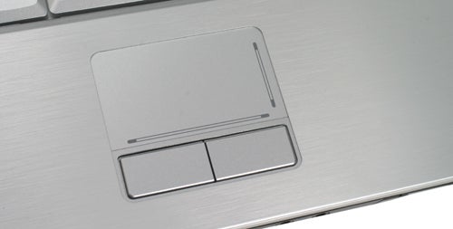 Dell XPS M1330 laptop touchpad and buttons close-up.