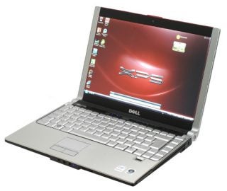 Dell XPS M1330 laptop with open lid on white background.