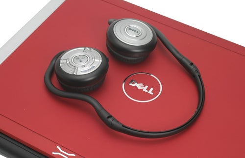Dell XPS M1330 laptop with earphones on red lid.