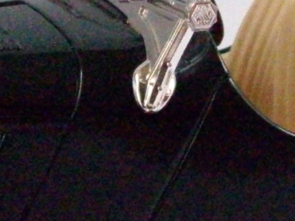 Close-up of a camera strap attached to a black bag.
