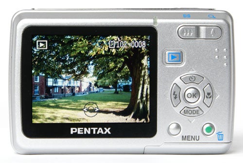 Pentax Optio E40 digital camera with a park scene on display.