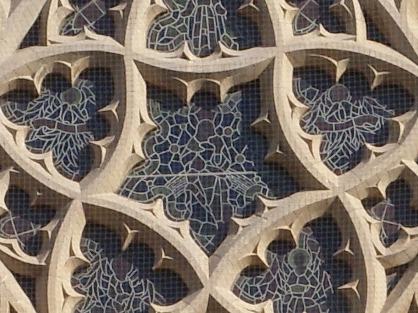 Intricate stone carving pattern on building facade.