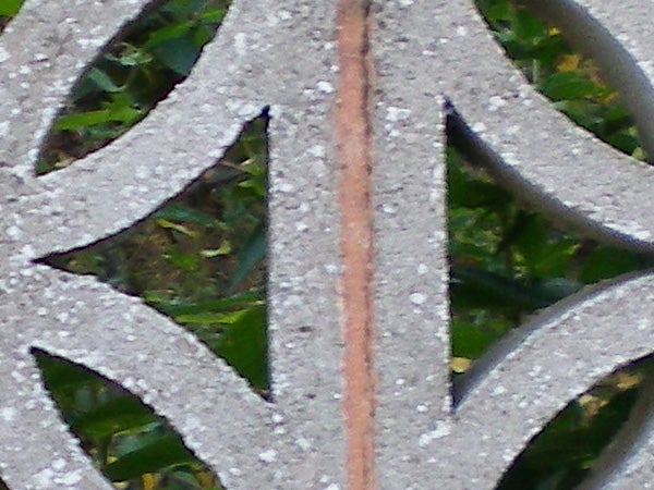 Close-up of a metal pattern with a blurred background.