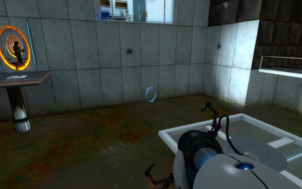 Screenshot from Portal showing in-game portal gun and created portals.