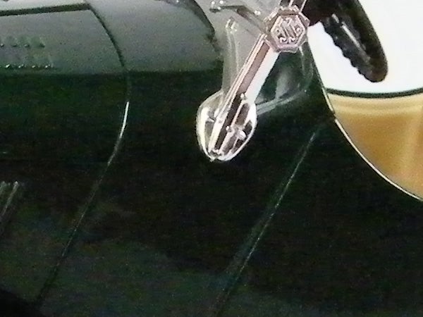 Close-up of a shiny object reflecting on a dark surface.