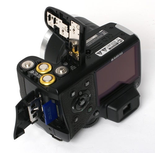 Fujifilm FinePix S8000fd camera showing open battery compartment.