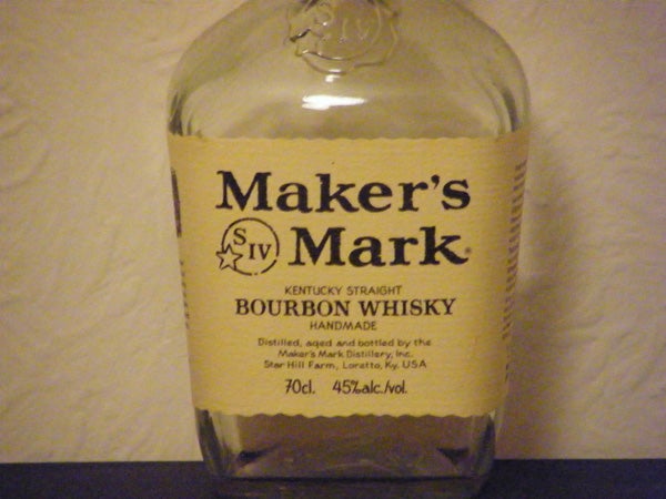 Bottle of Maker's Mark bourbon whiskey on a table.