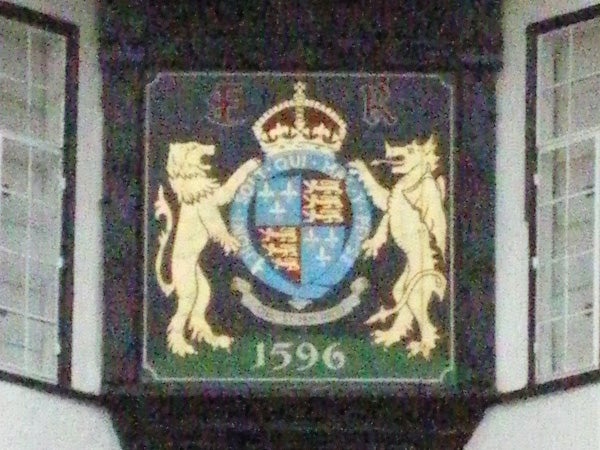 Blurry photo of a crest with lions and date 